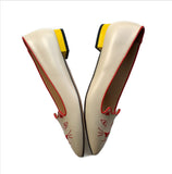 Charlotte Olympia Mid Century Kitty Cream flats with yellow heel and red accent